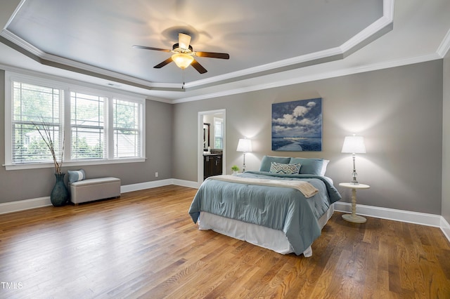 1013 Shasta Daisy Dr, Wake Forest, NC 27587 - bedroom with a tray ceiling, crown molding, wood finished floors, ensuite bathroom, and a ceiling fan