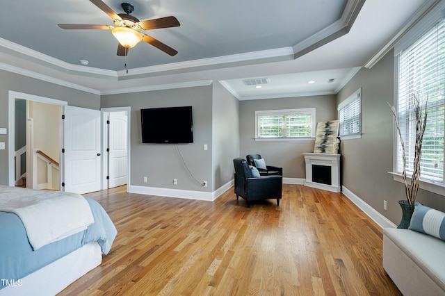 1013 Shasta Daisy Dr, Wake Forest, NC 27587 - bedroom with light wood-type flooring, recessed lighting, a fireplace, ornamental molding, and ceiling fan