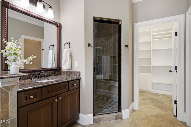 1013 Shasta Daisy Dr, Wake Forest, NC 27587 - full bathroom featuring a stall shower, vanity, a walk in closet, crown molding, and built in shelves
