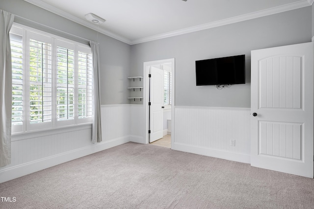 1013 Shasta Daisy Dr, Wake Forest, NC 27587 - unfurnished bedroom featuring carpet flooring, a wainscoted wall, and crown molding