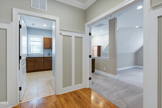 1013 Shasta Daisy Dr, Wake Forest, NC 27587 - hallway featuring crown molding and light wood-style flooring