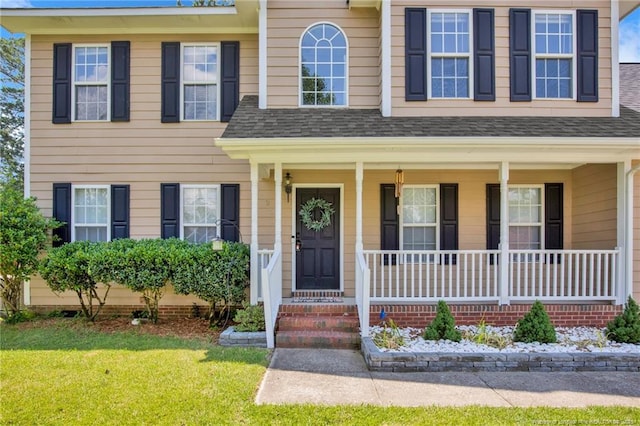 2505 Canford Ln, Fayetteville, NC 28304 - view of front of house with covered porch, roof with shingles, and a front yard