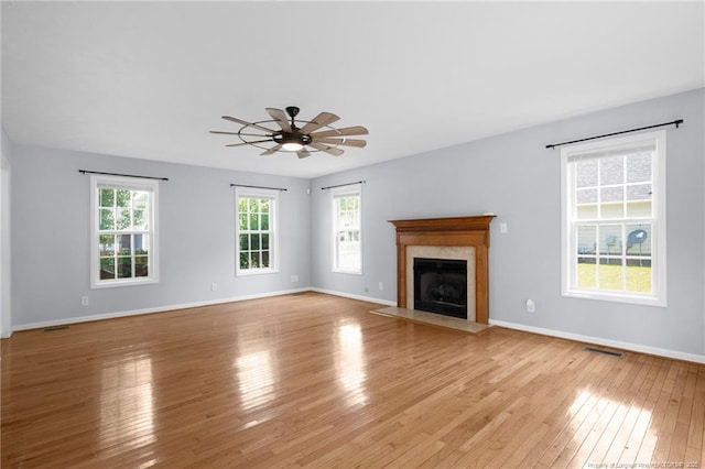 2505 Canford Ln, Fayetteville, NC 28304 - unfurnished living room featuring light wood-style flooring, ceiling fan, and a premium fireplace