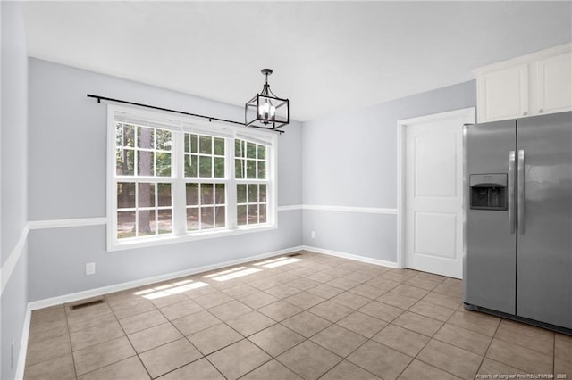 2505 Canford Ln, Fayetteville, NC 28304 - unfurnished dining area with a chandelier and light tile patterned floors