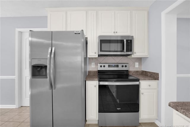 2505 Canford Ln, Fayetteville, NC 28304 - kitchen with stainless steel appliances, white cabinets, backsplash, and light tile patterned floors