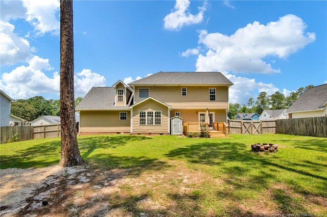 2505 Canford Ln, Fayetteville, NC 28304 - rear view of property featuring a fire pit, a fenced backyard, crawl space, and a wooden deck