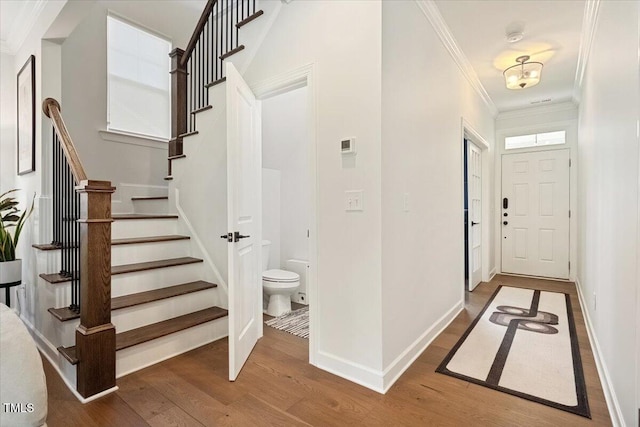 1848 Stagecoach Trl, Wendell, NC 27591 - foyer entrance featuring wood finished floors, ornamental molding, and stairs