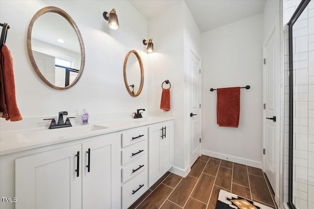 1848 Stagecoach Trl, Wendell, NC 27591 - bathroom featuring double vanity, tiled shower, and wood tiled floors