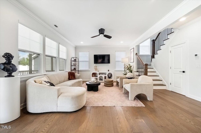 1848 Stagecoach Trl, Wendell, NC 27591 - living area with wood finished floors, ceiling fan, stairs, ornamental molding, and recessed lighting