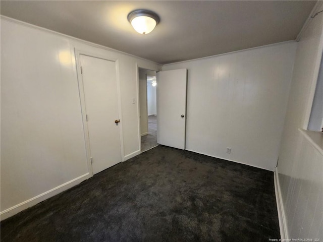 1227 E Martin Luther King Jr Dr, Maxton, NC 28364 - unfurnished bedroom with dark colored carpet and crown molding