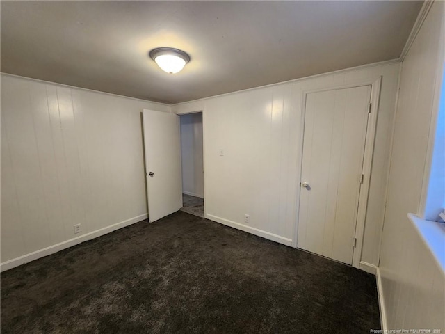 1227 E Martin Luther King Jr Dr, Maxton, NC 28364 - unfurnished bedroom featuring dark carpet and baseboards