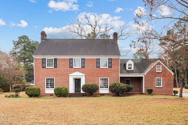 221 Whitfield St, Enfield, NC 27823 - colonial-style house with a chimney, a front lawn, brick siding, and crawl space