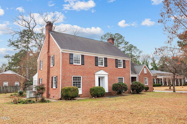221 Whitfield St, Enfield, NC 27823 - colonial home featuring a chimney, brick siding, and a shingled roof