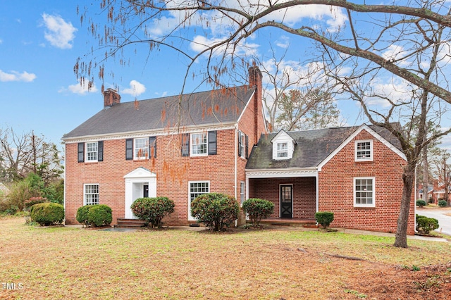 221 Whitfield St, Enfield, NC 27823 - view of front of property featuring a chimney, brick siding, a front lawn, and a shingled roof
