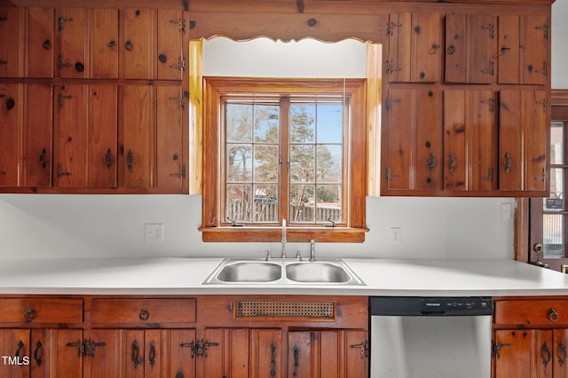 221 Whitfield St, Enfield, NC 27823 - kitchen featuring stainless steel dishwasher, brown cabinets, and light countertops