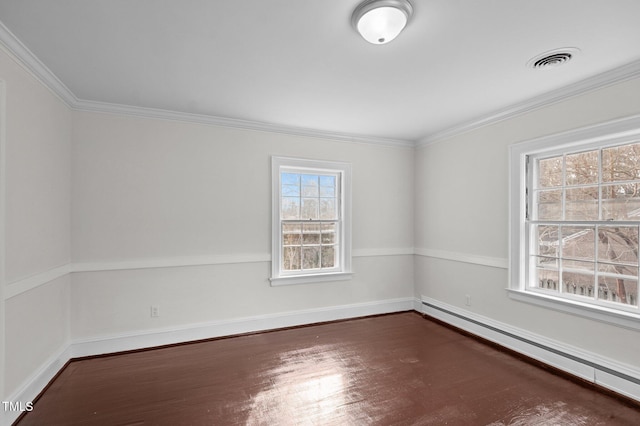 221 Whitfield St, Enfield, NC 27823 - spare room featuring a baseboard heating unit, dark wood-type flooring, and crown molding
