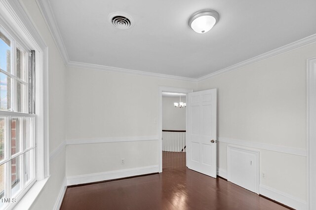 221 Whitfield St, Enfield, NC 27823 - empty room featuring wood finished floors, ornamental molding, and a chandelier