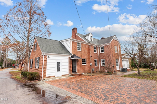 221 Whitfield St, Enfield, NC 27823 - view of home's exterior featuring a chimney and brick siding