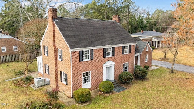 221 Whitfield St, Enfield, NC 27823 - colonial-style house featuring a chimney, roof with shingles, and entry steps