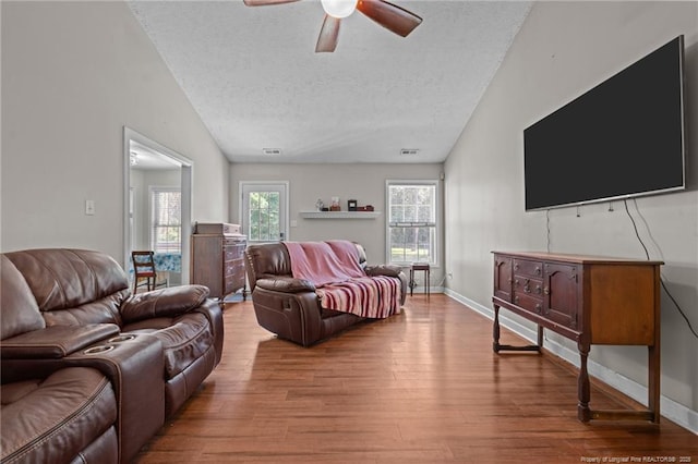 118 Bayou Ct, Raeford, NC 28376 - living area with a textured ceiling, lofted ceiling, a ceiling fan, and wood finished floors