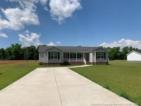 1484 Brayboy Rd, Rowland, NC 28383 - view of front of house featuring a front lawn, concrete driveway, a porch, and crawl space