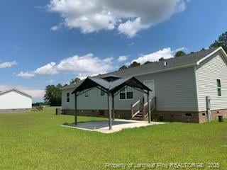 1484 Brayboy Rd, Rowland, NC 28383 - rear view of property featuring crawl space, a lawn, a gazebo, and a patio area