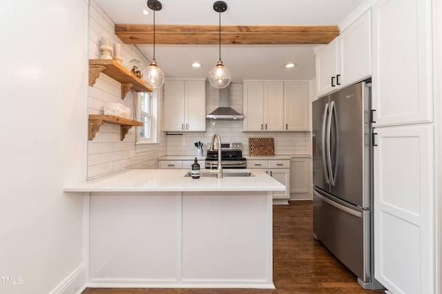 415 W Carver St, Durham, NC 27704 - kitchen featuring appliances with stainless steel finishes, wall chimney exhaust hood, a peninsula, white cabinetry, and light countertops