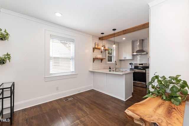 415 W Carver St, Durham, NC 27704 - kitchen with stainless steel electric stove, wall chimney range hood, a peninsula, healthy amount of natural light, and recessed lighting