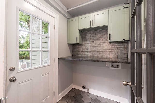 415 W Carver St, Durham, NC 27704 - washroom featuring cabinet space, hookup for a washing machine, dark tile patterned flooring, and hookup for an electric dryer