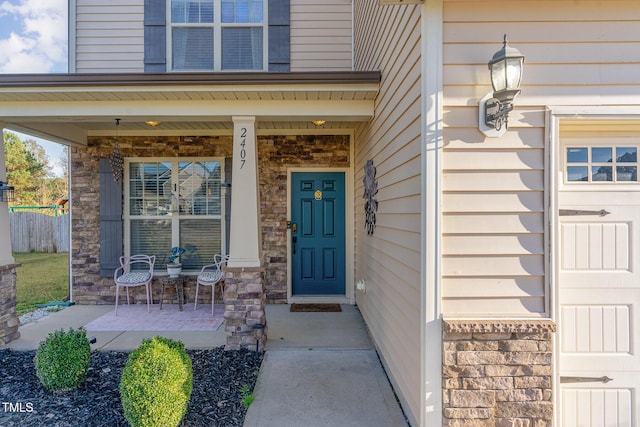 2407 Cattail Pond Dr, Zebulon, NC 27597 - doorway to property featuring covered porch