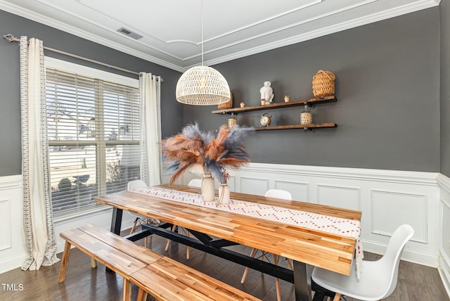 2407 Cattail Pond Dr, Zebulon, NC 27597 - dining room featuring a wainscoted wall, ornamental molding, dark wood-style floors, and a decorative wall