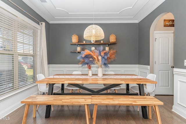 2407 Cattail Pond Dr, Zebulon, NC 27597 - dining area featuring arched walkways, a wainscoted wall, wood finished floors, crown molding, and a chandelier