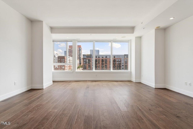 400 W N St Unit 732, Raleigh, NC 27603 - unfurnished room featuring wood finished floors, a view of city, and recessed lighting