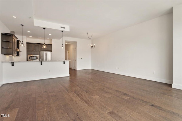400 W N St Unit 732, Raleigh, NC 27603 - unfurnished living room featuring a chandelier, dark wood-type flooring, and recessed lighting