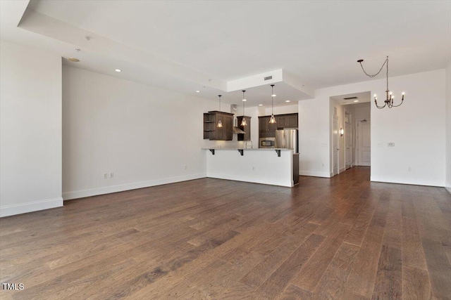 400 W N St Unit 732, Raleigh, NC 27603 - unfurnished living room featuring a chandelier, dark wood-style floors, and recessed lighting