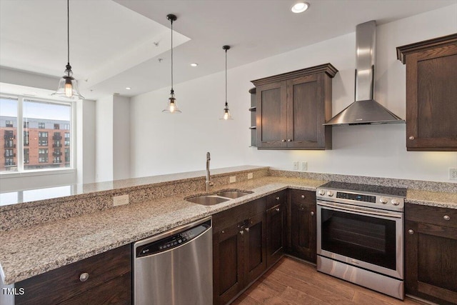 400 W N St Unit 732, Raleigh, NC 27603 - kitchen with stainless steel appliances, wall chimney exhaust hood, dark brown cabinets, hanging light fixtures, and recessed lighting