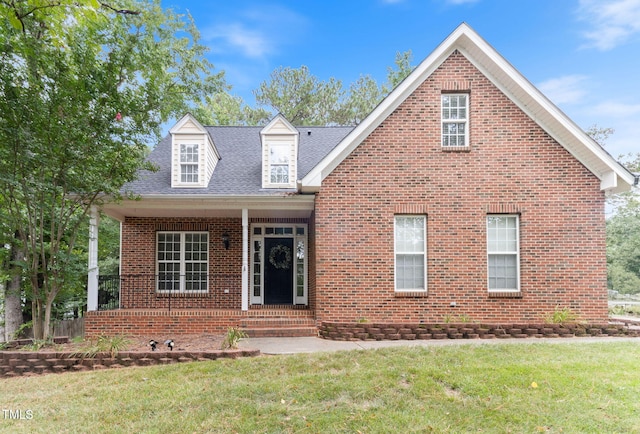 8508 Parlange Woods Ln, Wake Forest, NC 27587 - view of front of home with a front yard, brick siding, covered porch, and roof with shingles