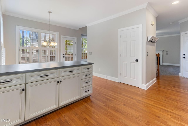 8508 Parlange Woods Ln, Wake Forest, NC 27587 - kitchen featuring a chandelier, ornamental molding, light wood-style flooring, decorative light fixtures, and white cabinetry