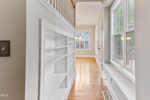 8508 Parlange Woods Ln, Wake Forest, NC 27587 - hall with light wood-style flooring and a chandelier