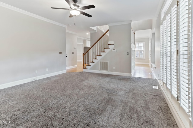 8508 Parlange Woods Ln, Wake Forest, NC 27587 - unfurnished living room featuring ceiling fan, stairs, carpet flooring, and ornamental molding