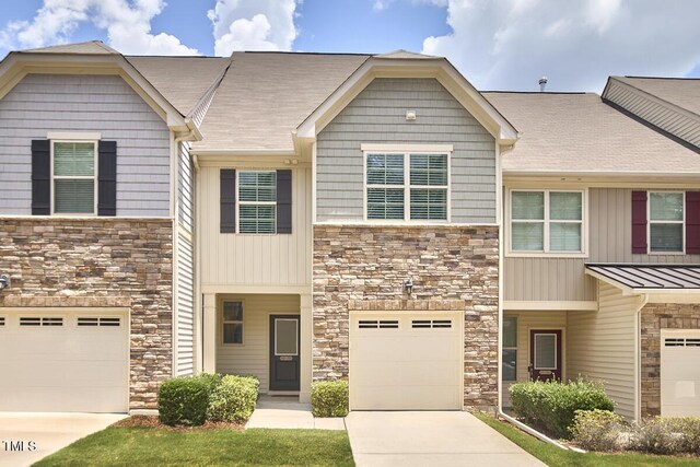 21 Intuition Cir, Durham, NC 27705 - view of property with stone siding, an attached garage, and driveway