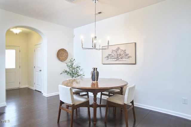 21 Intuition Cir, Durham, NC 27705 - dining space featuring arched walkways, dark wood-style flooring, and a chandelier