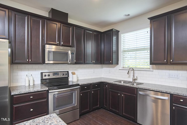 21 Intuition Cir, Durham, NC 27705 - kitchen with stainless steel appliances, dark wood-type flooring, light stone countertops, and backsplash