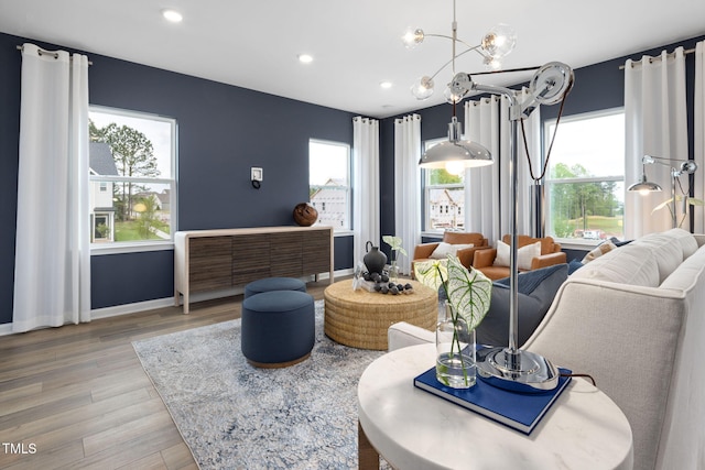 1516 Tamarisk Ln, Durham, NC 27703 - living room featuring light wood-style floors, plenty of natural light, a chandelier, and recessed lighting