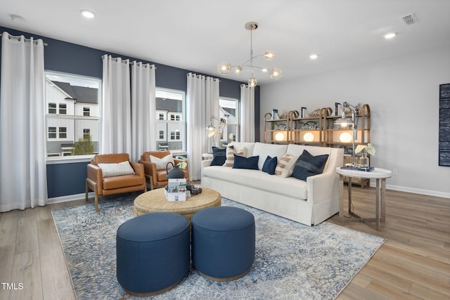 1516 Tamarisk Ln, Durham, NC 27703 - living room featuring wood finished floors, a chandelier, and recessed lighting
