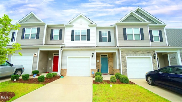 103 Liam St Unit 108, Clayton, NC 27520 - view of property featuring driveway, an attached garage, a front yard, and stone siding