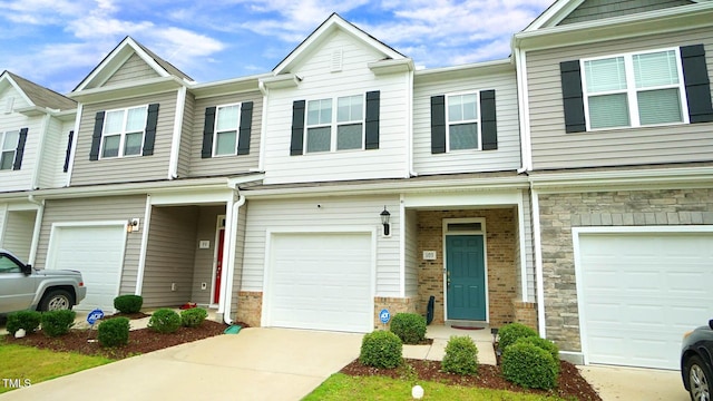 103 Liam St Unit 108, Clayton, NC 27520 - townhome / multi-family property with stone siding, a garage, and concrete driveway