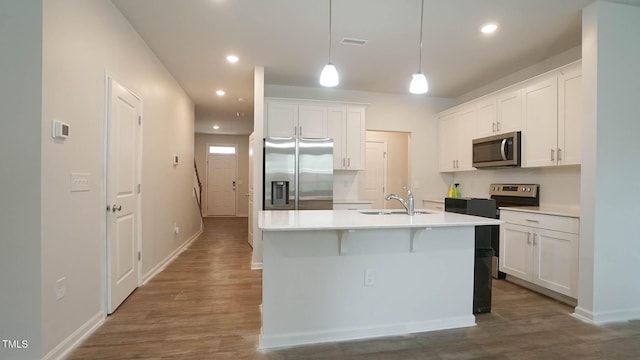 103 Liam St Unit 108, Clayton, NC 27520 - kitchen featuring stainless steel appliances, white cabinetry, dark wood-style flooring, and recessed lighting
