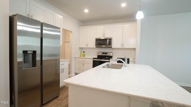 103 Liam St Unit 108, Clayton, NC 27520 - kitchen featuring stainless steel appliances, wood finished floors, white cabinets, decorative light fixtures, and recessed lighting