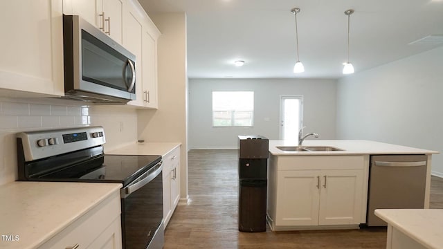 103 Liam St Unit 108, Clayton, NC 27520 - kitchen featuring stainless steel appliances, dark wood-style flooring, white cabinets, tasteful backsplash, and light countertops